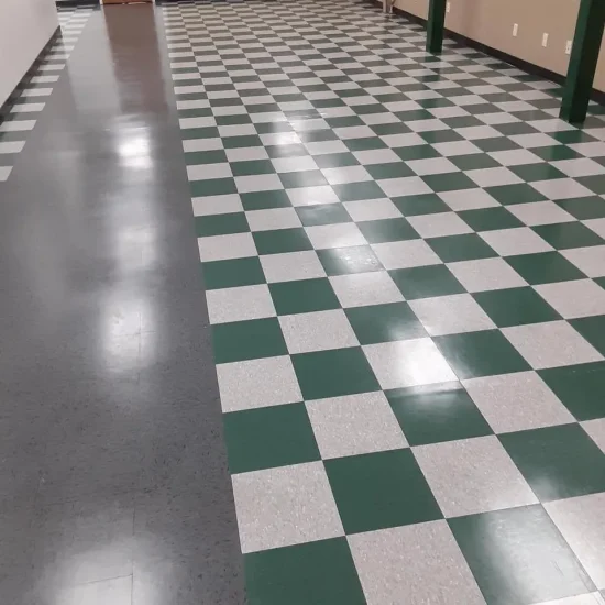 A green and white checkered floor inside a building, creating a vibrant and inviting atmosphere.