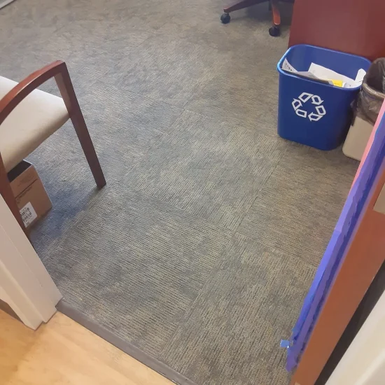 A room featuring a desk and a chair, creating a simple workspace environment.