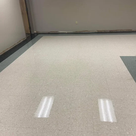 A polished and gleaming office floor reflecting light, showcasing a clean and tidy workspace environment.